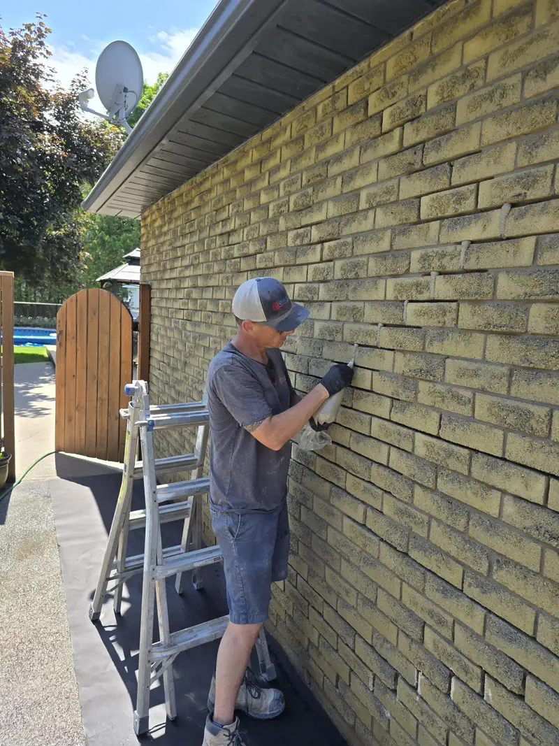 Masonry repair work on a brick wall in Paris, Ontario